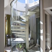 View of the spiral staircase that leads to glass, interior design, stairs, gray, white