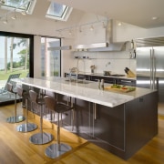 View of contemporary kitchen which features island, stainless countertop, interior design, kitchen, real estate, gray, brown