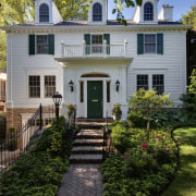 Exterior view of this traditional remodeled home - architecture, backyard, cottage, estate, facade, farmhouse, grass, historic house, home, house, landscaping, lawn, mansion, neighbourhood, outdoor structure, porch, property, real estate, residential area, siding, walkway, window, yard, gray