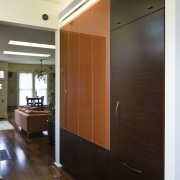 View of kitchen which features custom refrigerator cabinetry. cabinetry, ceiling, door, floor, flooring, hardwood, interior design, room, wall, wood, wood flooring, brown