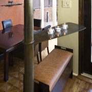 View of a kitchen which features a structural chair, desk, floor, flooring, furniture, hardwood, room, table, wood, brown