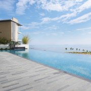 Exterior view of the Springtide Residence on Penang apartment, condominium, estate, home, house, leisure, property, real estate, resort, sea, sky, swimming pool, vacation, villa, teal, white, gray