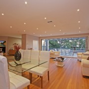 View of this contemporary home by Denton Homes apartment, architecture, ceiling, daylighting, estate, floor, flooring, hardwood, home, house, interior design, living room, property, real estate, room, window, wood, wood flooring, orange, brown