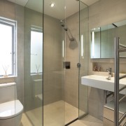 View of renovated bathroom which features glass shower bathroom, floor, flooring, glass, interior design, plumbing fixture, room, tile, gray, brown