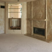 Interior view of this remodeled traditional condo by ceiling, fireplace, floor, flooring, hardwood, hearth, home, interior design, laminate flooring, living room, room, tile, wall, wood flooring, brown, gray