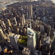 View of the Bank of America Tower in aerial photography, bird's eye view, building, city, cityscape, daytime, downtown, landmark, metropolis, metropolitan area, sky, skyline, skyscraper, tower, tower block, urban area, black, gray