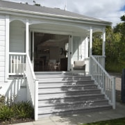 View of this home with unique design - cottage, deck, home, house, outdoor structure, porch, real estate, residential area, siding, white, gray