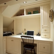 View of desk area under a staircase. - cabinetry, ceiling, countertop, cuisine classique, desk, floor, flooring, furniture, hardwood, home, interior design, kitchen, room, wall, wood, brown, orange