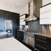 View of kitchen area that features cafe-styled bar, cabinetry, countertop, cuisine classique, interior design, kitchen, real estate, room, white