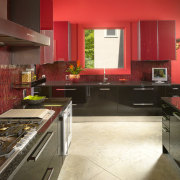 View of kitchen with red feature wall, red cabinetry, countertop, floor, flooring, hardwood, interior design, kitchen, laminate flooring, room, wood flooring, brown, red