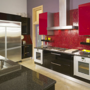 View of kitchen with red feature wall, red cabinetry, countertop, cuisine classique, home appliance, interior design, kitchen, room, brown, gray