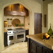 View of traditionally styled kitchen with Tudor-style arch, cabinetry, countertop, cuisine classique, interior design, kitchen, room, brown, orange