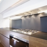 View of contemporary kitchen with wooden island and architecture, ceiling, countertop, daylighting, interior design, kitchen, under cabinet lighting, white, brown