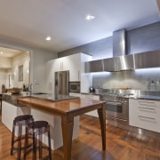 View of contemporary renovated kitchen featuring timber floors, cabinetry, ceiling, countertop, cuisine classique, floor, flooring, hardwood, interior design, kitchen, laminate flooring, real estate, room, wood, wood flooring, gray, brown