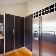 View of the contemporary kitchen - View of cabinetry, countertop, floor, home appliance, interior design, kitchen, real estate, refrigerator, room, gray, black