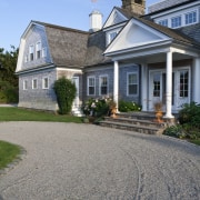 Exterior view of a New-England styled vacation home. building, cottage, driveway, estate, facade, farmhouse, historic house, home, house, mansion, property, real estate, residential area, roof, siding, sky, suburb, walkway, window, gray, teal