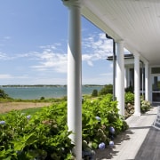 Exterior view of a New-England styled vacation home. cottage, estate, home, house, outdoor structure, property, real estate, sky, villa, gray