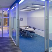 Interior view of offices which features glass cavity architecture, daylighting, floor, glass, leisure centre, real estate, structure, blue
