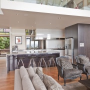 View of open-plan kitchen featuring an island with house, interior design, living room, real estate, table, gray