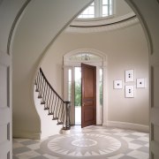 View of atrium of this Regency-styled home with arch, architecture, ceiling, daylighting, estate, floor, flooring, home, interior design, molding, real estate, stairs, structure, window, gray