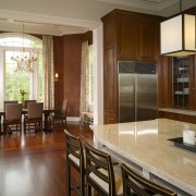 View of kitchen in this Regency-styled house which cabinetry, countertop, dining room, floor, flooring, hardwood, interior design, kitchen, real estate, room, window, wood flooring, brown