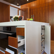 View of kitchen which features oak floors, kitchen cabinetry, countertop, floor, hardwood, interior design, kitchen, brown, gray