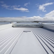 View of the cantilevered roof of the South boat, cloud, daylighting, daytime, deck, fixed link, line, roof, sea, sky, water, yacht, gray