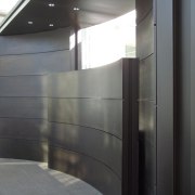 View of brass walls fabricated by Craft Metals architecture, daylighting, glass, gray, black