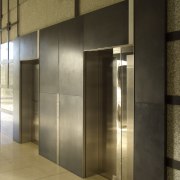 View of brass walls fabricated by Craft Metals door, glass, interior design, lobby, wall, brown