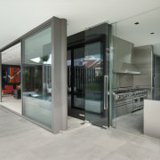 View of the wet kitchen which features stainless architecture, door, glass, house, real estate, gray