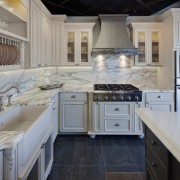 View of a traditional styled kitchen which features cabinetry, countertop, cuisine classique, floor, interior design, kitchen, room, gray