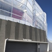View of a metal roller door at the architecture, building, commercial building, corporate headquarters, daylighting, daytime, elevation, facade, glass, headquarters, line, sky, structure, window, gray