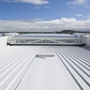 View of the cantilevered roof of the South boat, daylighting, deck, dock, fixed link, roof, sea, sky, water, yacht, white