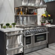 View of a kitchen which features DCS oven countertop, gas stove, home appliance, kitchen, kitchen appliance, kitchen stove, major appliance, oven, refrigerator, small appliance, gray, black