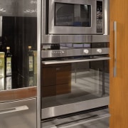 View of a kitchen which features DCS oven countertop, home appliance, kitchen, kitchen appliance, kitchen stove, major appliance, microwave oven, oven, gray, brown