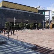View of Aotea Square which features paving, planters, architecture, building, campus, city, downtown, metropolitan area, mixed use, neighbourhood, plaza, public space, structure, town square, urban design, black, gray