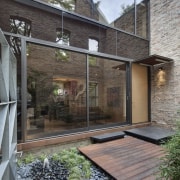 View of a renovated three-story home, built to architecture, courtyard, facade, home, house, outdoor structure, real estate, residential area, siding, gray