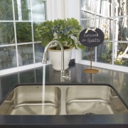View of a kitchen which features a stainless home, interior design, property, window, gray, white