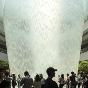 Jewel Changi Airport boasts a hub with quite architecture, crowd, event, fountain, tree, white
