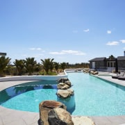 The pool has an organic feel with rocks 