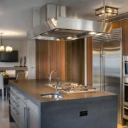 View of contemporary kitchen and dining area with cabinetry, countertop, cuisine classique, interior design, kitchen, real estate, room, gray, brown