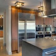 View of contemporary kitchen and dining area with cabinetry, countertop, cuisine classique, hardwood, interior design, kitchen, real estate, gray, brown