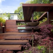 View of timber outdoor seating area with large architecture, backyard, courtyard, deck, home, house, landscaping, outdoor structure, wood, yard, red