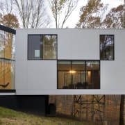 Exterior view of a contemporary house that features architecture, building, facade, home, house, real estate, window, gray, brown