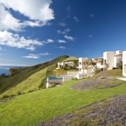 Exterior view of Mediterranean styled house which is architecture, cloud, coast, cottage, estate, grass, home, horizon, house, property, real estate, residential area, sea, sky, terrain, villa