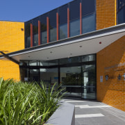 Exterior view of the Poche Centre which was architecture, building, facade, home, house, real estate, residential area, brown