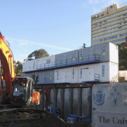 View of shipping containers from Royal Wolfe Australia. asphalt, construction, construction equipment, demolition, metropolitan area, transport, vehicle, teal