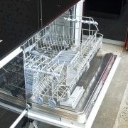 View of kitchen which features integrated Smeg dishwasher black, white