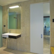 Interior view of an apartment which features a architecture, bathroom, ceiling, daylighting, door, floor, flooring, glass, interior design, wall, window, brown, gray