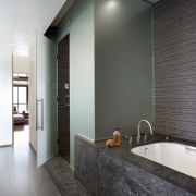 View of master bedroom and bathroom in subdued architecture, bathroom, ceiling, daylighting, floor, flooring, home, interior design, room, tile, wall, wood flooring, gray, black